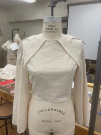 a mannequin with a white blouse on it