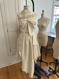 a white dress on a mannequin in a room