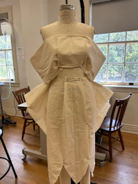 a white dress on a mannequin in a room