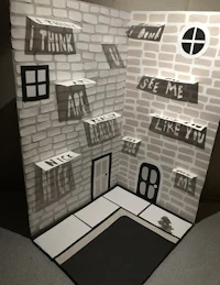 a paper cut out of a house with words on it